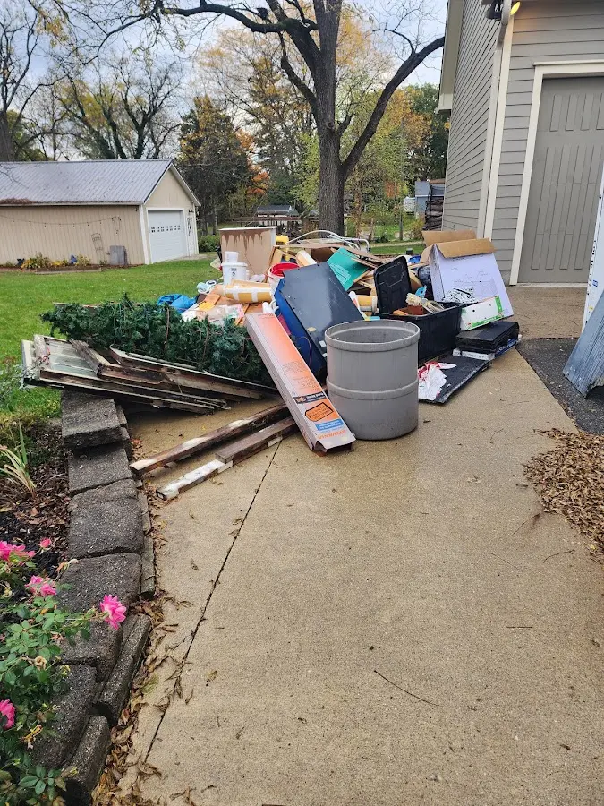 Dumpster being loaded with debris for Estate Cleanout Dumpster Rental in Elmhurst